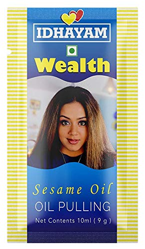 Idhayam Wealth Sesame Oil packaging with a woman's face on a blue and yellow striped background