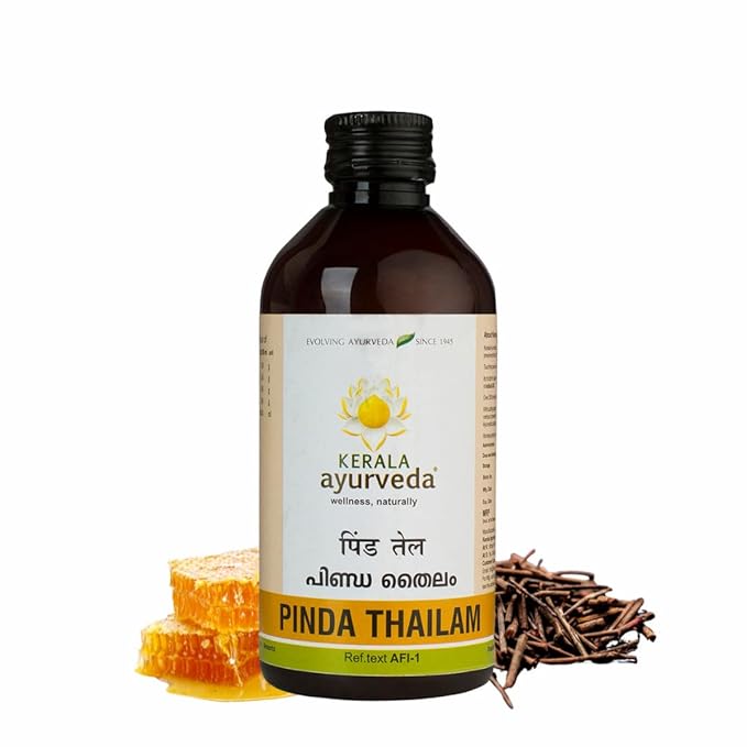 Bottle of Kerala Ayurveda Pinda Thailam with honeycomb and sticks on a white background