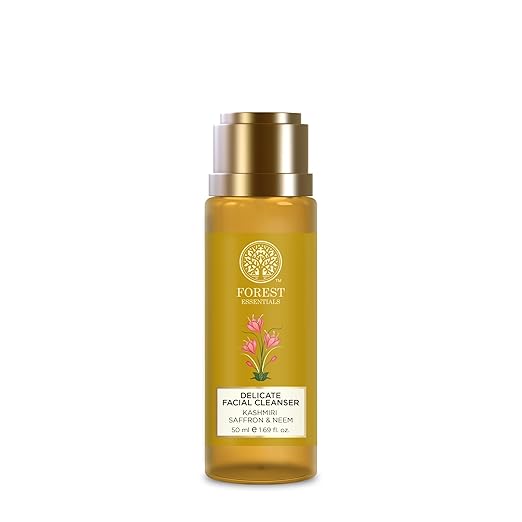 Yellow facial cleanser bottle with gold cap on a white background