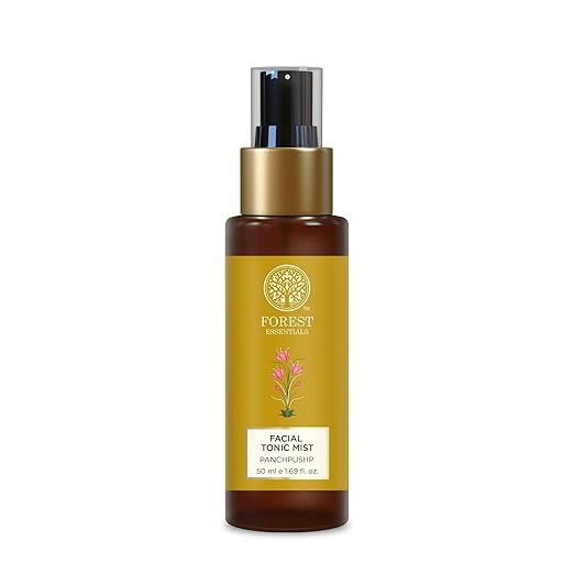 Facial tonic mist bottle with gold cap on a white background