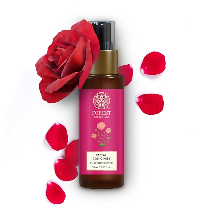 Facial tonic mist bottle with a red rose and petals on a white background