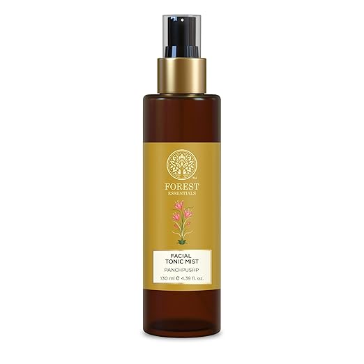 Facial tonic mist bottle with gold label on a white background